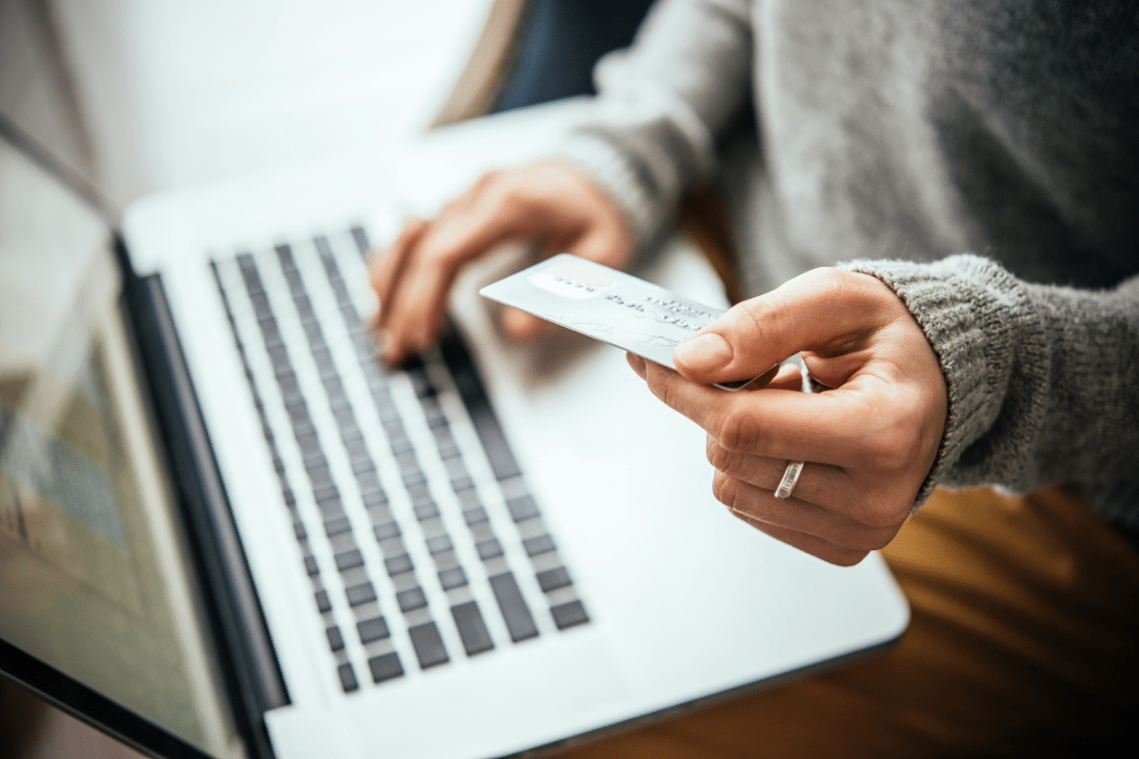 Integrated Software Payments 1 - Sprout Pay Person on a laptop holding a credit card