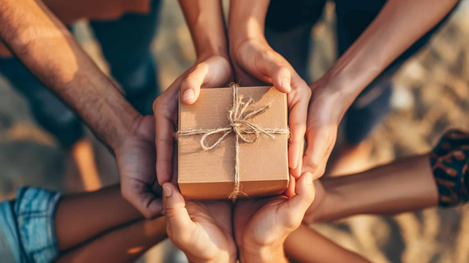 group offering gift with hands together scaled - Payment Processing Devices - Sprout Pay